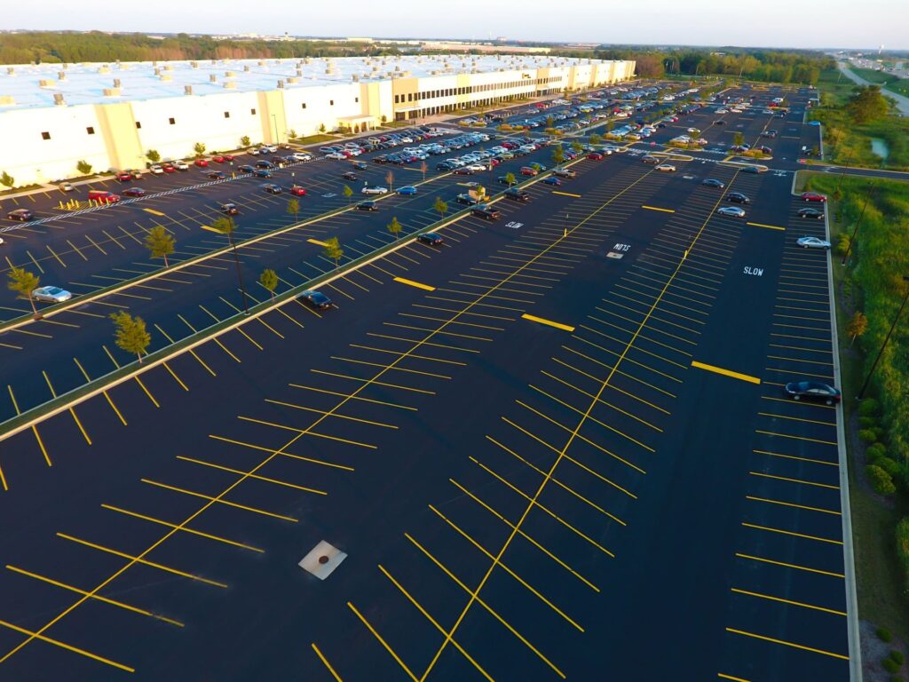 a brand new parking lot with freshly painted stripes on the asphalt